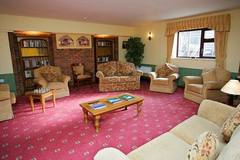The living room with armchairs and a red carpet