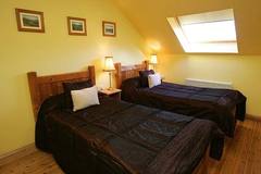 Twin room with two single beds and a skylight
