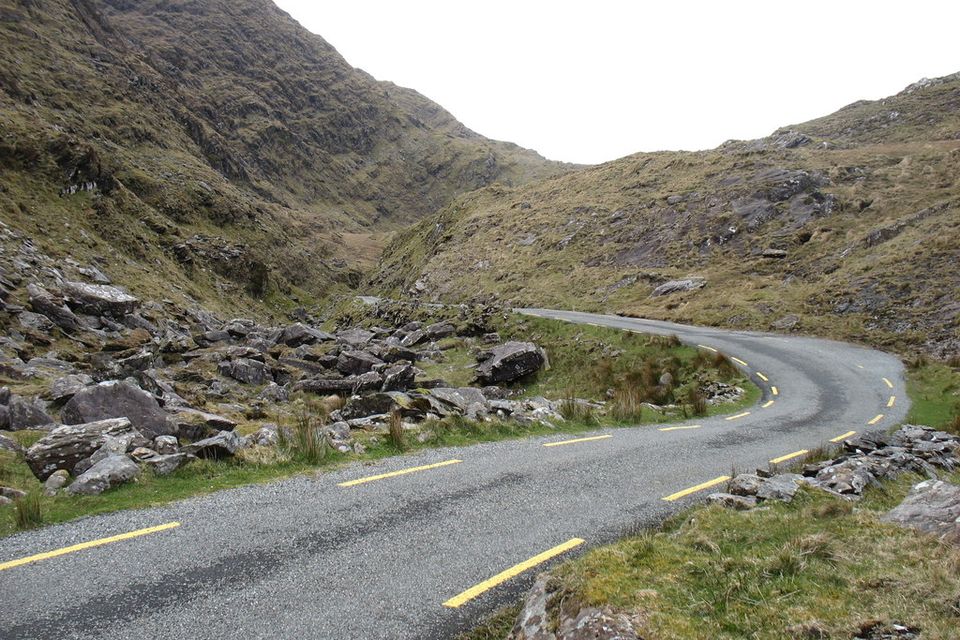 A narrow road winding through the rocky Ballaghbeama Gap