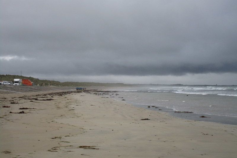 The wide sands of Banna Strand under a grey sky