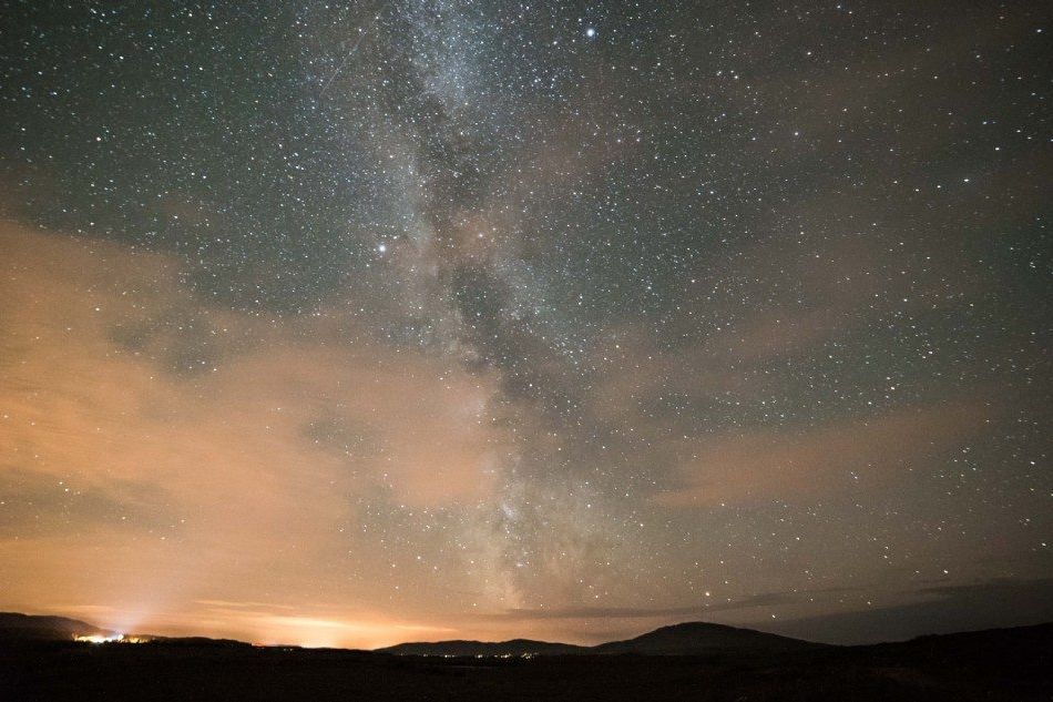 The Milky Way over dark hills