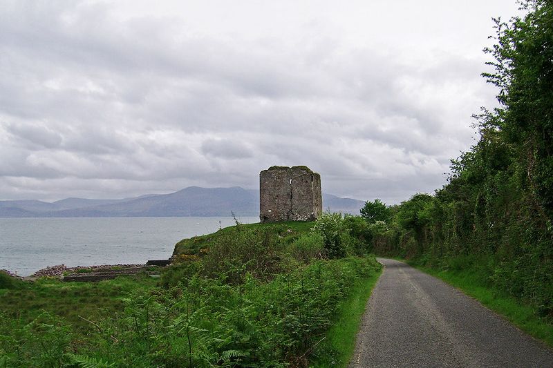 The ruined tower of Minard Castle above the sea