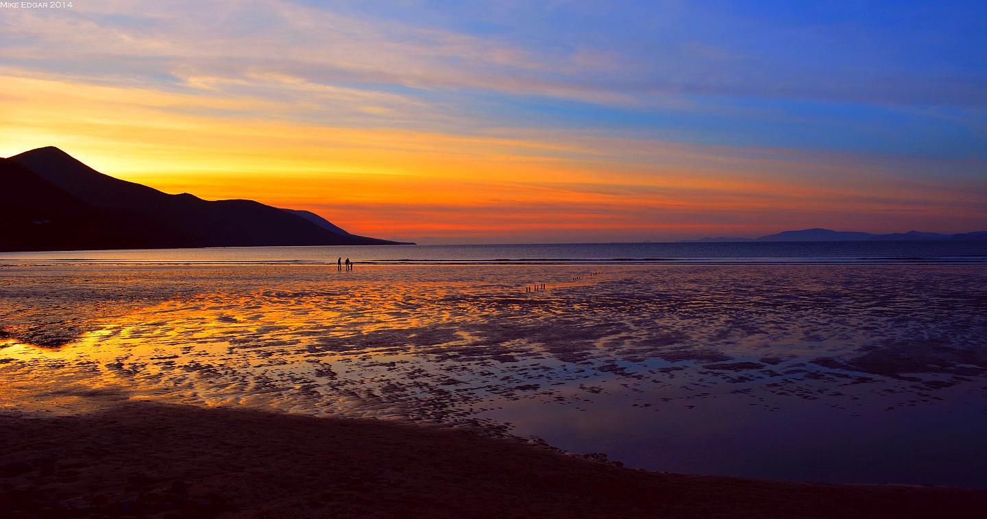 Sunset over Rossbeigh strand at low tide, with the mountains of the Dingle Peninsula across the bay