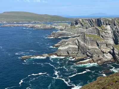 Layered sea cliffs with waves breaking below