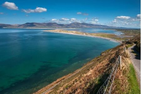 The long sand spit of Rossbeigh Strand seen from the hillside above Dingle Bay