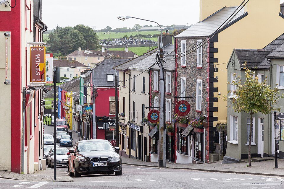 Upper Bridge Street in Killorglin, with hanging signs and stone shopfronts