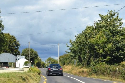 The N70 road at Kilderry with trees beside it