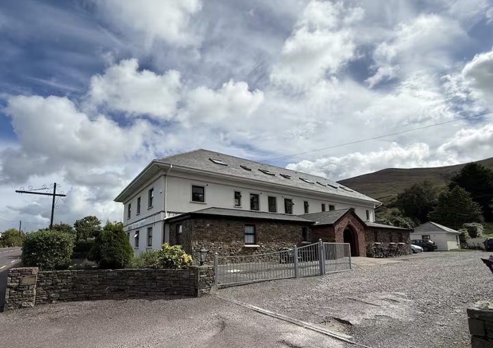 Kerry Ocean Lodge from the road, with mountains behind
