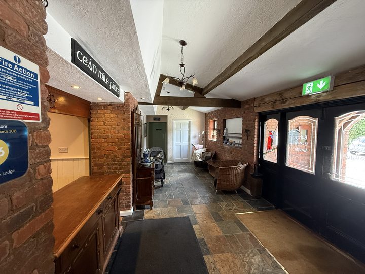 The reception hall with a slate floor, wooden counter and a Céad Míle Fáilte sign